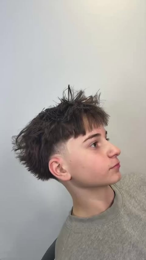 Profile of a person with a modern undercut hairstyle